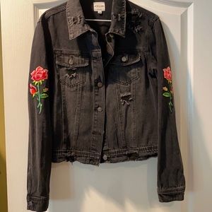 Distressed black denim jacket with flower patches
